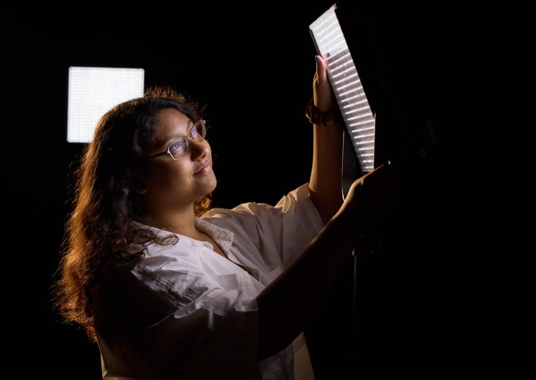student playing with lighting