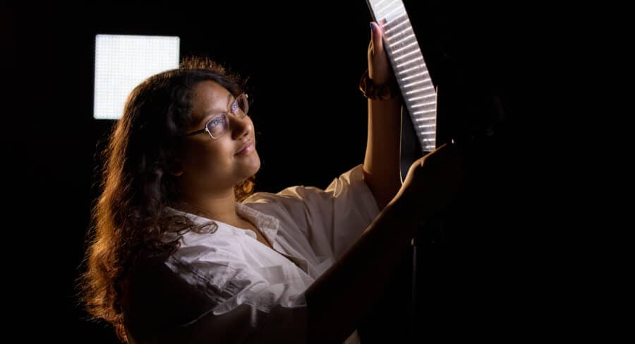 student playing with lighting