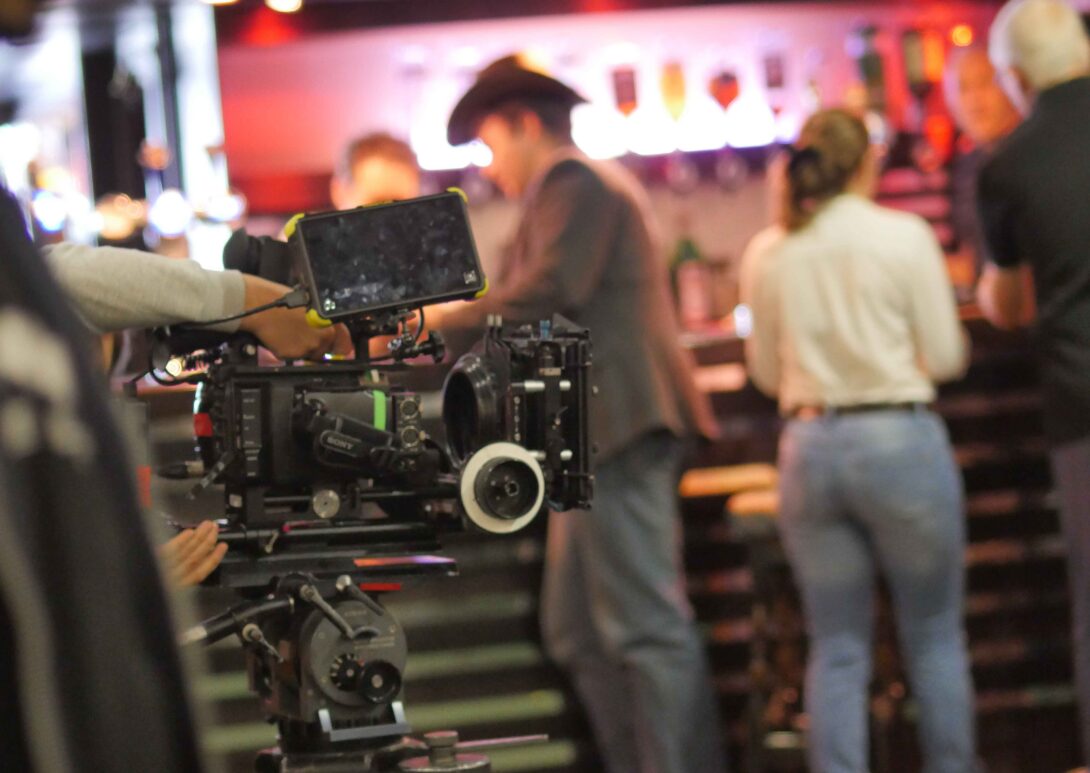 out of focus image of film camera and students