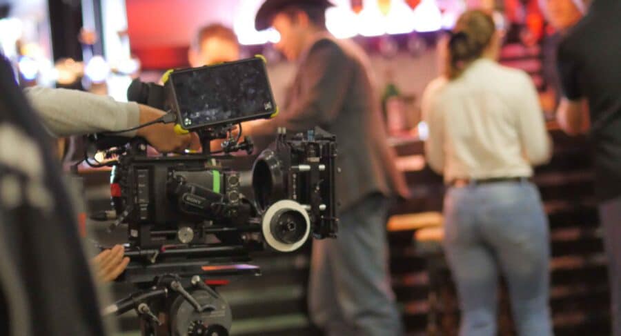 out of focus image of film camera and students